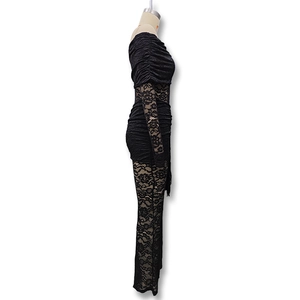 Detail of floral lace texture and ruched design on this black long sleeve bodysuit