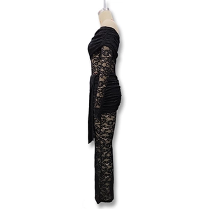 Close-up of intricate black floral lace pattern and sheer fabric texture on slim-fit bodysuit