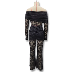 Rear view of black lace jumpsuit featuring floral cut-outs and flared trousers detail