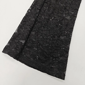 Close-up detail of sexy black lace jumpsuit showing floral patterns and mesh transparency