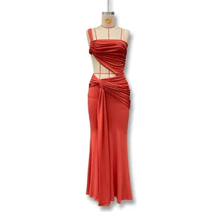 Detail of coral red one-shoulder dress showing side waist cutout and ruched fabric texture