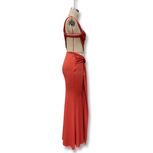 Detail showing side drawstrings and ruched texture on the brick red bodycon dress