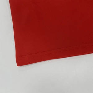 Close-up of high-quality double-needle hem stitching on red knit halter top fabric