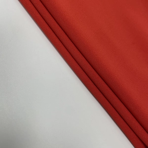 Close-up of red high-density knitted fabric showing soft texture and premium quality