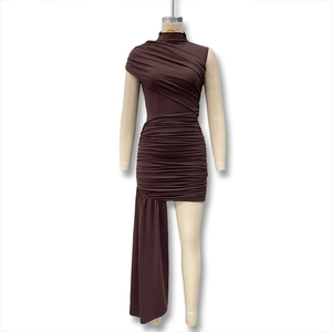 Detail of dark brown ruched bodycon dress with asymmetric hem and long draped streamers