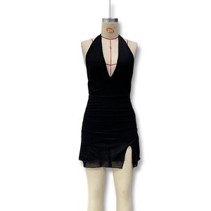 Detail view of the ruched texture and side slit on the black halter neck bodycon dress