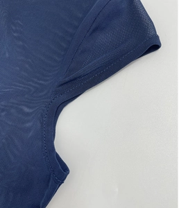 Detail of navy blue mesh fabric with breathable honeycomb structure and fine stitching