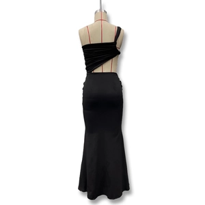 Detail of black one-shoulder maxi dress with side cut-outs and ruched fabric texture