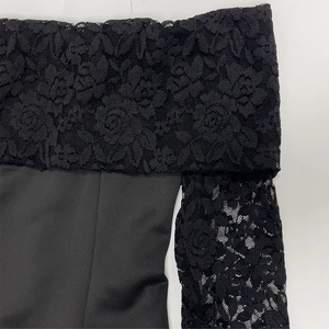 Détail de la broderie en dentelle noire élégante avec motifs de roses sur une robe