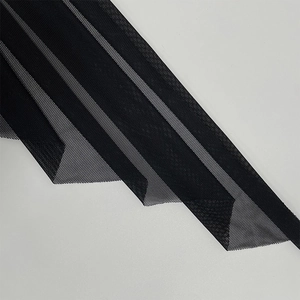 Close-up of black mesh fabric showing fine hexagonal holes and semi-transparent texture