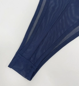 Detail shot of navy blue mesh fabric with high-quality stitching on bodysuit edges