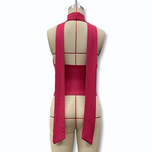 Detail view of the rose red halter top featuring stylish long back neck tie ribbons