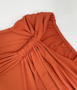 Detail view of ruched fabric on a caramel backless maxi dress for women in summer