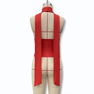 Detail view showing back of red halter top with long tie-up ribbons and open back design