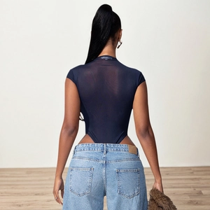 Navy blue mesh bodysuit with hollow waist design paired with washed blue denim jeans