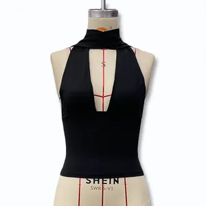 Detailed close-up of a black halter neck crop top featuring a deep V-neck hollow out design