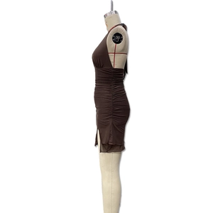 Detail of a brown halter bodycon dress featuring ruched sides and a side slit design
