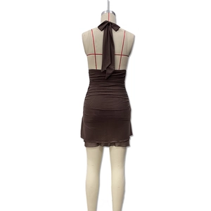 Detail view of ruched deep brown halter dress showing backless design and soft fabric