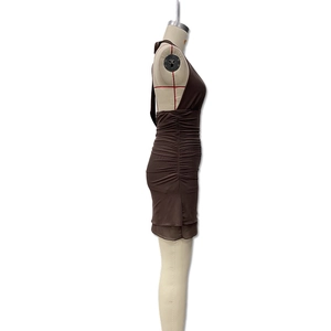 Detail view of dark brown halter neck dress with side ruched design and layered hem