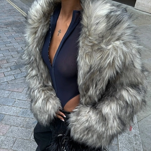 Close-up of sheer blue mesh bodysuit with metal buckle detail under a faux fur coat