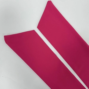 Detail of rose red elastic knitted arm sleeves with a unique diagonal geometric cut