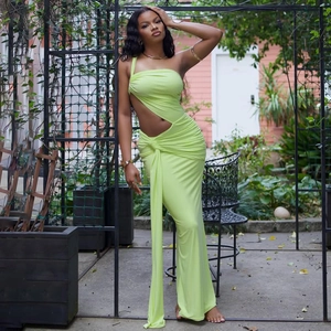 Detail of lime green one-shoulder maxi dress with side cutout and ruching details