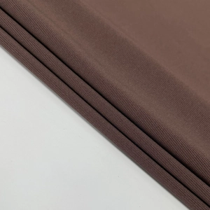 Close-up of the brown ribbed knit fabric texture and multi-layer folded material details
