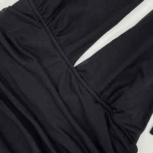 Detail shot of black ruched mesh dress with sexy deep V-neck and sheer fabric texture