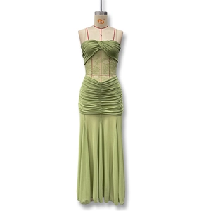 Detail of green ruched maxi dress featuring lace cut-outs and twisted strapless bodice