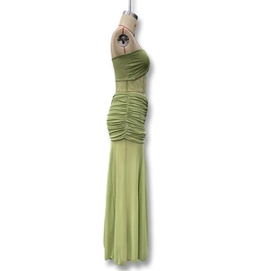Detail of light green ruched bodycon maxi skirt with elegant fishtail hemline