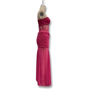 Detail of rose red strapless dress featuring floral lace patchwork and gathered pleats
