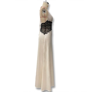 Close-up of champagne satin fabric and intricate black floral lace on a slim-fit dress