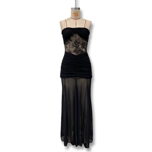 Detail of black strapless maxi dress featuring lace patchwork and ruched mesh texture