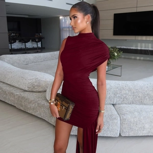 Detail of burgundy ruched bodycon dress with asymmetric neckline and elegant side streamer