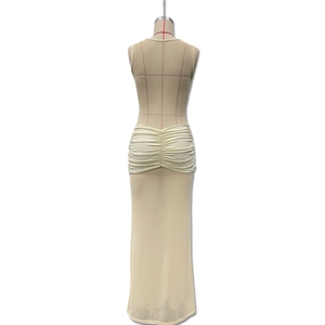 Detail of the sheer beige mesh dress showing gathered ruching and mermaid tail hemline