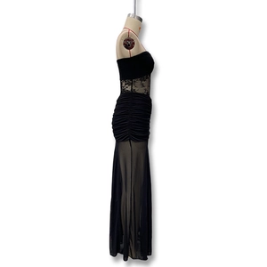 Detail of black strapless maxi dress with sheer lace waist and ruched bodycon design