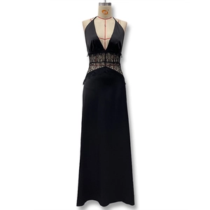 Detail of the elegant deep V-neckline and intricate black lace patchwork on the waist