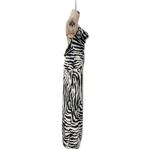 Side view detail of zebra print maxi dress featuring backless cut and high side slit
