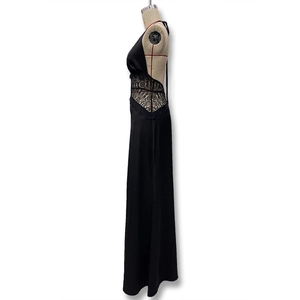 Detail of elegant black lace patchwork on high waist backless evening maxi dress