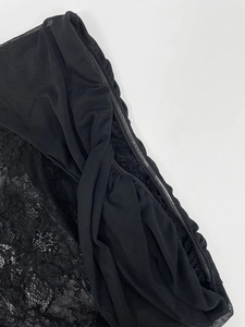 Detail of black lace and mesh fabric with non-slip silicone strip on dress edge