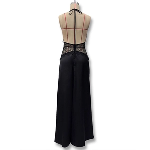 Detail of elegant black backless dress showing delicate lace waist and satin fabric