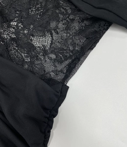 Detail of elegant black floral lace and mesh texture on this sleeveless summer dress