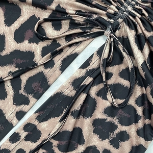 Detail of the leopard print fabric featuring adjustable drawstring and ruched side seam