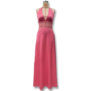 Detail of rose pink satin dress featuring waist lace patchwork and backless halter neck