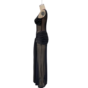 Detail of elegant black mesh dress featuring side ruching and slimming sleeveless design