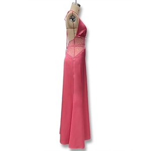 Close-up of pink satin dress featuring intricate lace patchwork and open back detail