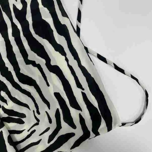 Close-up detail of sexy black and white zebra print fabric with thin shoulder straps