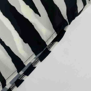 Detailed close-up showing the high-quality stitching and zebra print hem of the dress
