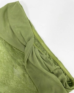 Detail of green mesh dress showing floral lace, ruched fabric and silicone non-slip strip