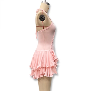 Close-up of pink halter dress showing ruffled hemline and decorative side buttons